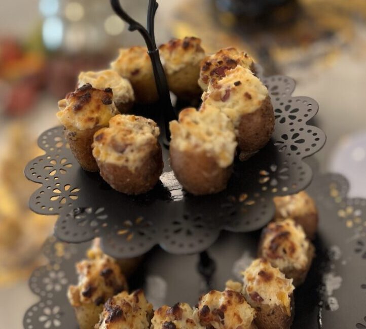 Elegant plate of bite-sized pastries with a creamy topping and a decorative handle.